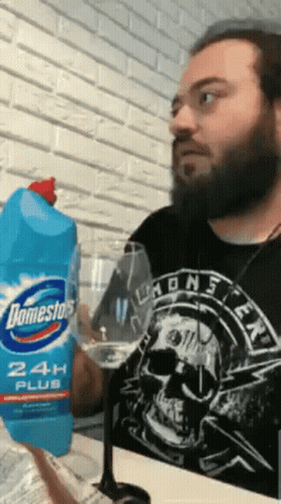 Man In Skull Shirt Holding Domestos GIF