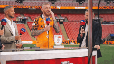 Man In Sky Sports Jersey Behind Table GIF