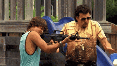 Man In Snake Shirt Pointing Gun At Tank Top Man GIF