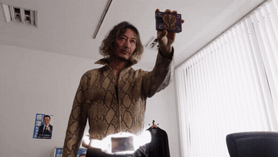 Man In Snakeskin Jacket Holding Card With Snake GIF