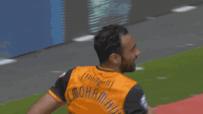 Man In Soccer Uniform Running On Red Field GIF