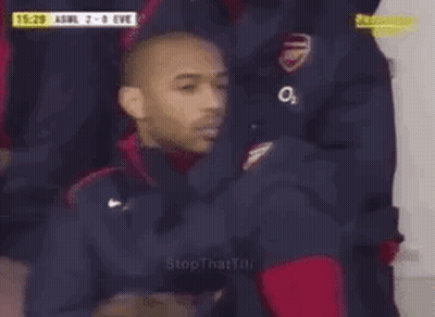 Man In Soccer Uniform Sitting In Stands GIF