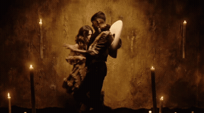 Man In Sombrero Next To Woman In Long Dress GIF