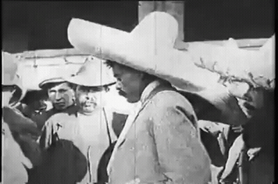Man In Sombrero Standing In Front Of Group GIF