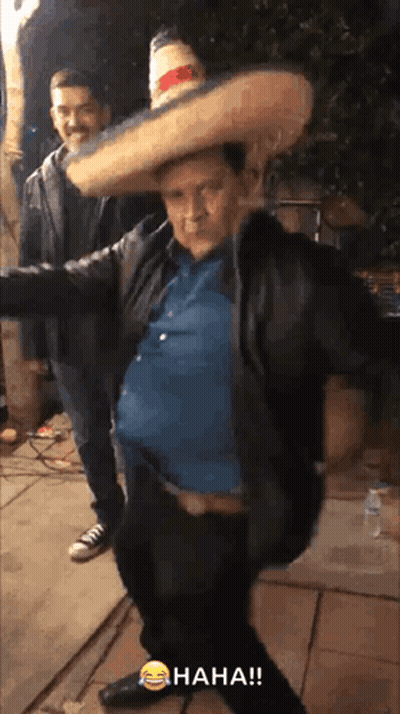 Man in Sombrero Standing Next to Man in Jacket