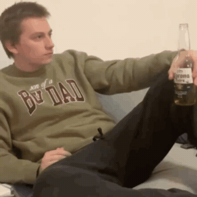 Man In Son Of A Dad Sweatshirt Holding Corona Beer GIF