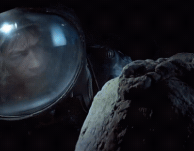 Man In Space Suit Looking Out Window GIF