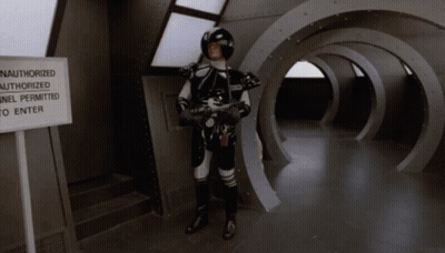 Man In Space Suit Near Authorized Tunnel Sign GIF