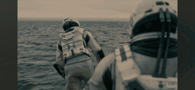 Man In Space Suit Walking Across Ocean GIF