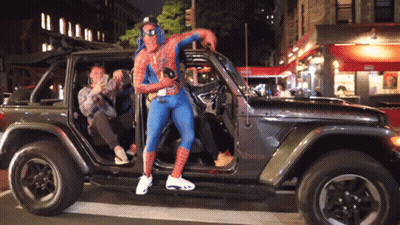 Man In Spider-Man Costume Standing In Jeep GIF