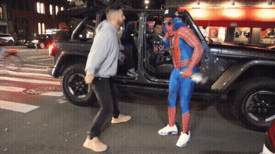 Man In Spiderman Costume Beside Jeep GIF
