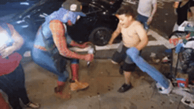 Man In Spiderman Costume Beside Shirtless Boy GIF