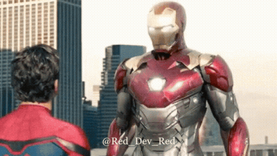 Man In Spiderman Costume Next To Iron Man GIF