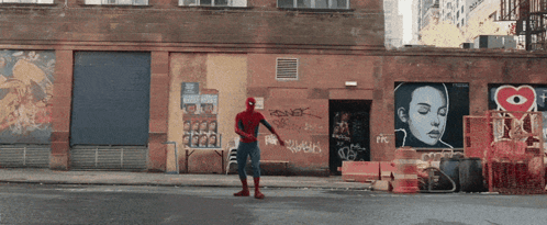 Man In Spiderman Costume With Graffiti Building GIF