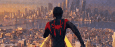 Man In Spiderman Suit Standing In Front Of City GIF