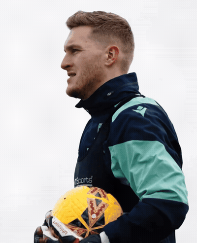 Man In Sports Jacket Holding Ball GIF