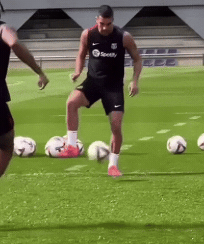 Man In Spotify Shirt Kicking Soccer Ball GIF