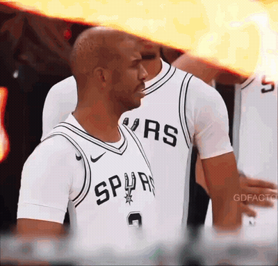 Man In Spurs Jersey Stands In Front Of Team GIF