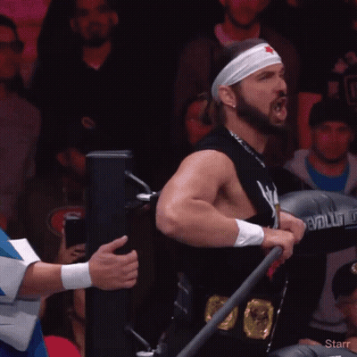 Man In Star Headband Holding Evolution Boxing Glove GIF