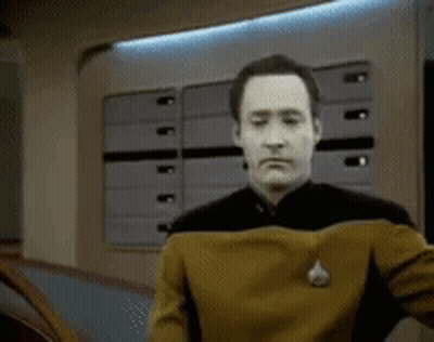 Man In Star Trek Uniform Holding Chest GIF