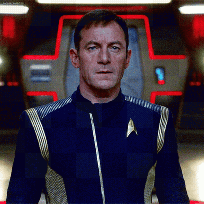 Man In Star Trek Uniform In Front Of Red Light GIF