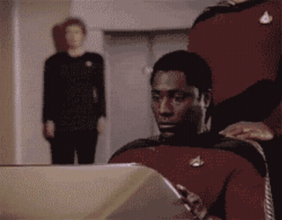 Man In Star Trek Uniform Sitting In Front Of Laptop GIF