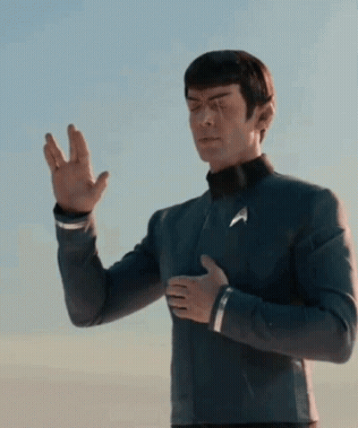 Hombre con uniforme de Star Trek de pie en un cielo azul GIF