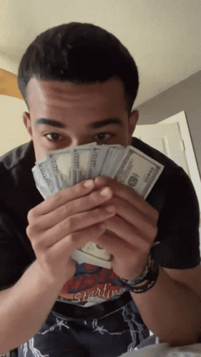 Man In Starting Shirt Holding Money GIF