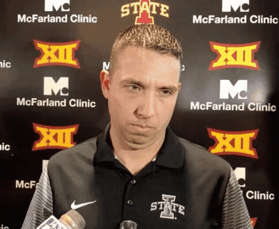 Man In State Shirt In Front Of McFarland Clinic Sign GIF