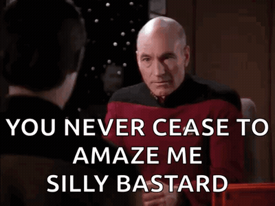 Man In Stoixima Shirt Talking On Phone GIF