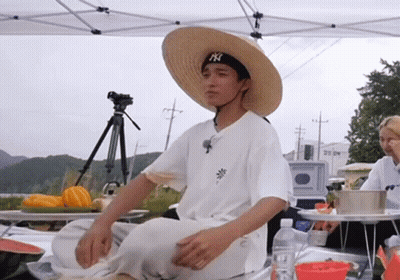 Man In Straw Hat And NY Hat Sitting GIF