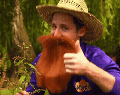 Man In Straw Hat And Purple Shirt Wiggles GIF