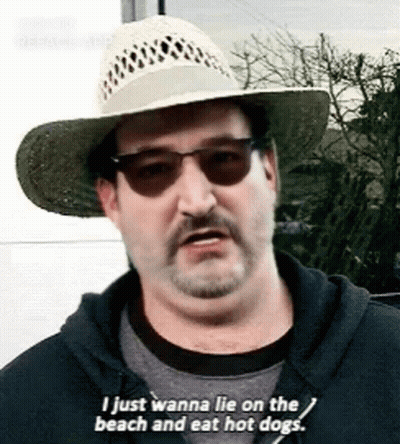 Man In Straw Hat And Sunglasses Saying I Just Wanna Lie On The Beach And Eat Hot Dogs GIF