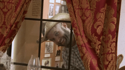 Man In Straw Hat Looking Out Window GIF