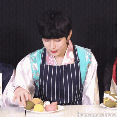 Man In Striped Apron Holding Plate Of Food GIF