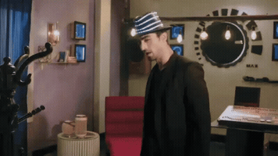 Man In Striped Hat Standing By Piano GIF