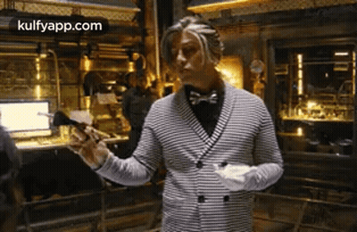 Man In Striped Jacket And Bow Tie Holding Paper GIF