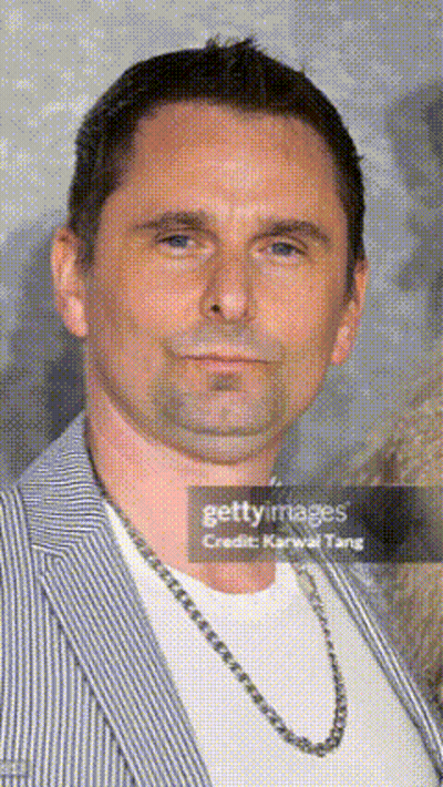Man In Striped Jacket And Chain Featured In Newspaper Article GIF