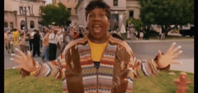 Man In Striped Jacket Standing In Crowd GIF