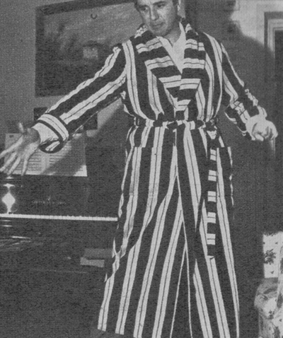 Man In Striped Robe Holding Broom GIF