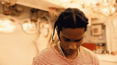 Man In Striped Shirt And Necklace Looking Down GIF