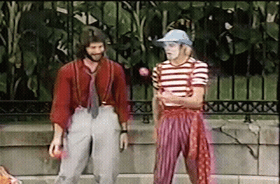 Man In Striped Shirt And Suspenders Standing Next To Another Man GIF