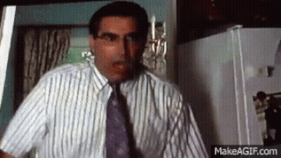 Man In Striped Shirt And Tie In Kitchen GIF