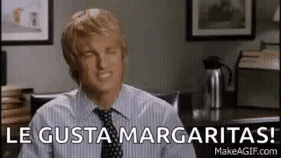 Man In Striped Shirt And Tie Smiling At Desk GIF