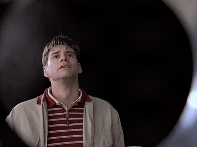 Man In Striped Shirt And White Jacket Looking Up GIF