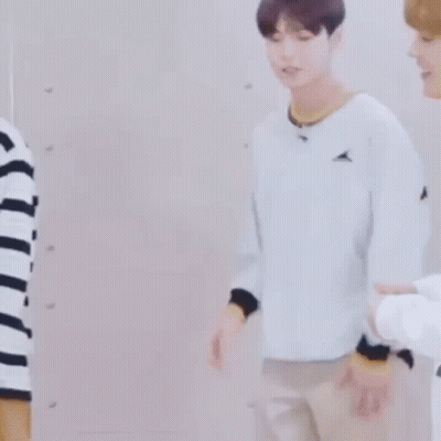 Man In Striped Shirt Beside Man In White Sweater GIF