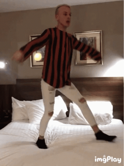 Man In Striped Shirt Dancing On Bed With ImgPlay GIF