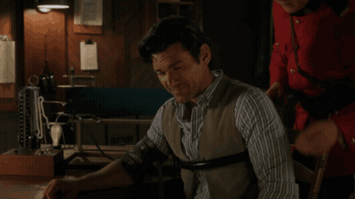 Man In Striped Shirt Examined By Red Jacket GIF
