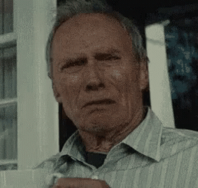 Man In Striped Shirt Holding Coffee Looking At Camera GIF