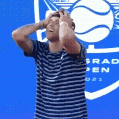 Man In Striped Shirt Holding Head Grad Open GIF